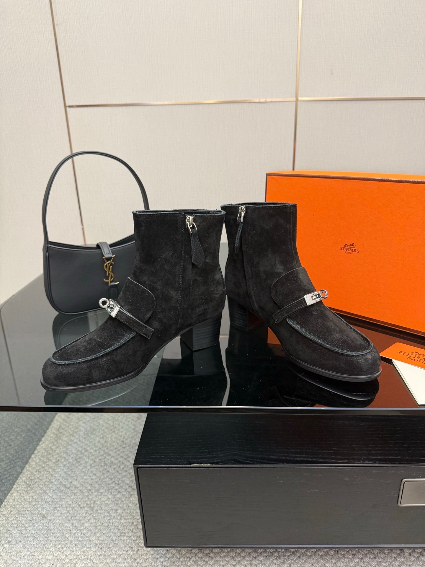 Black women’s ankle boots with buckled strap accents and low block heels