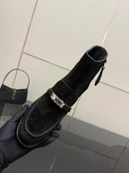 Black women’s ankle boot with square buckle strap and mid-height block heel