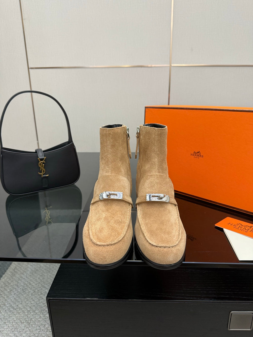 Women’s tan suede ankle boots with block heels and silver side buckles.