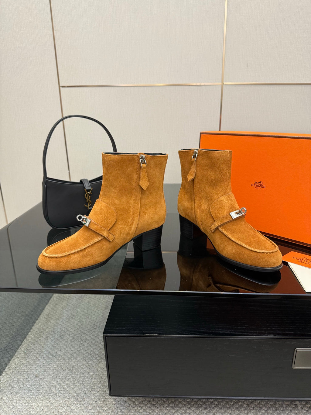 Tan suede ankle boots with buckle details and block heels, pair shown side by side.