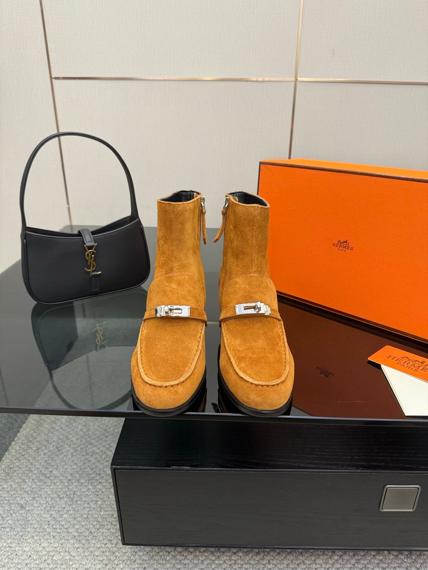 Tan suede ankle boots with buckle strap and block heel, presented as a pair.