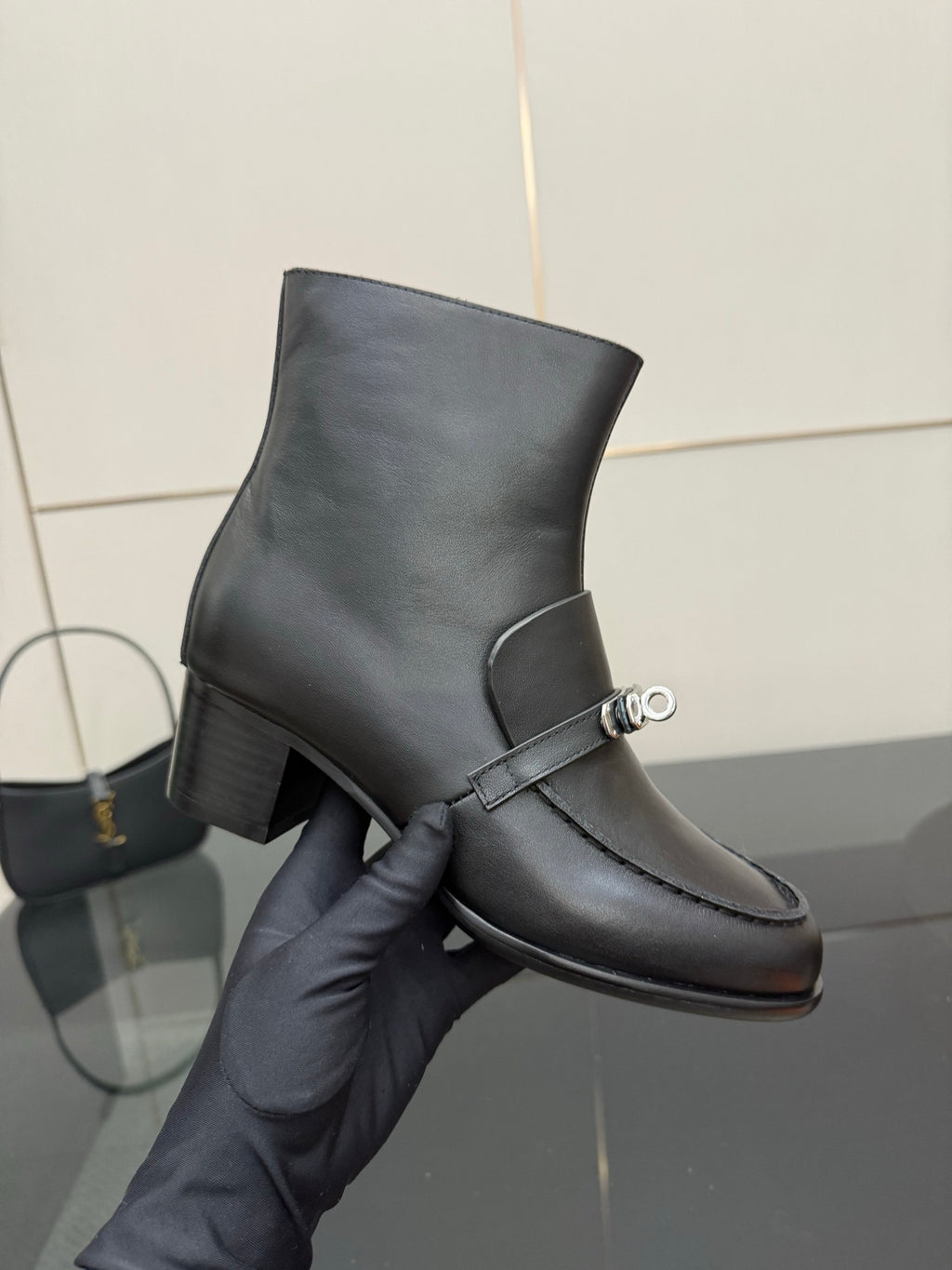 Hermes ladies black leather ankle boot on hand, silver buckle strap detail