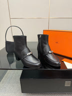 Hermes ladies black leather ankle boots with silver buckles and block heels, side