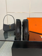 Hermes ladies black leather ankle boots with side panels, pair view
