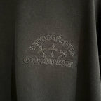 Black fabric with gray tone-on-tone logo embroidery across the chest