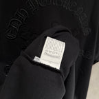 Black sweatshirt sleeve with white care label and stitched seam detail