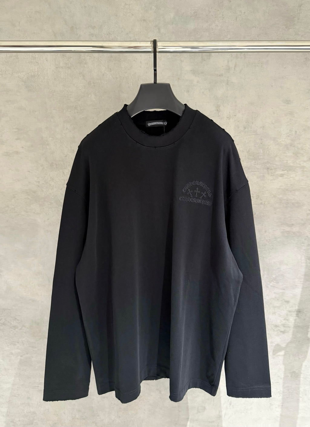 Black long-sleeve crewneck sweatshirt with small chest logo embroidery