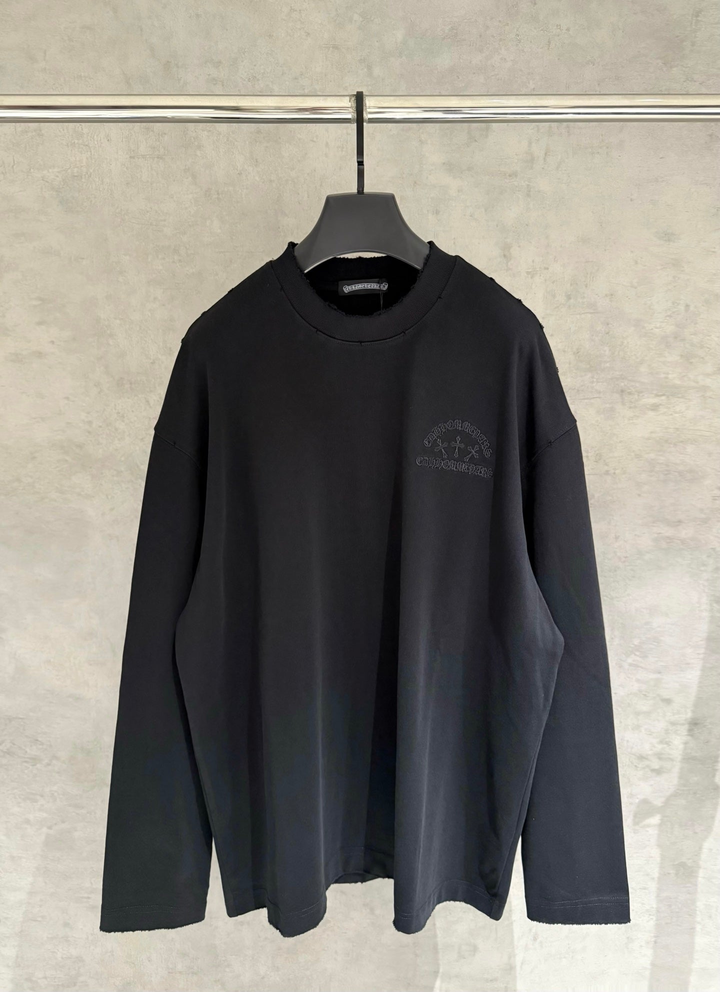 Black long-sleeve crewneck sweatshirt with small chest logo embroidery