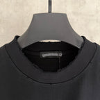 Black crewneck sweatshirt neckline with ribbed collar and inner brand label