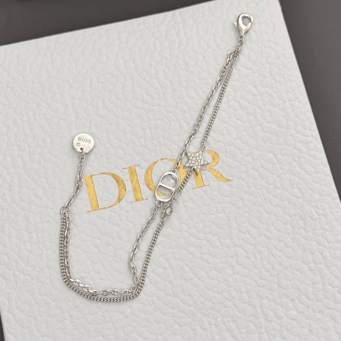 Silver-tone necklace with DIOR pendant and small round disc charm