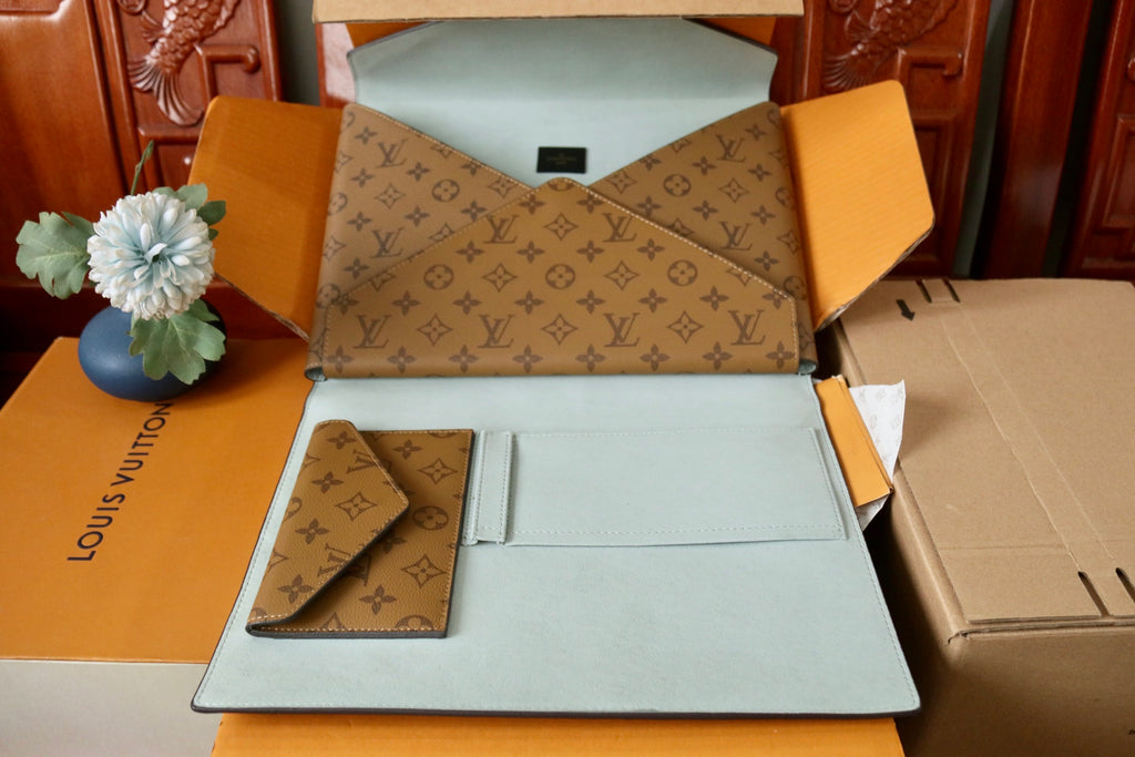Louis Vuitton monogram envelope bag open with light blue lining and card slot
