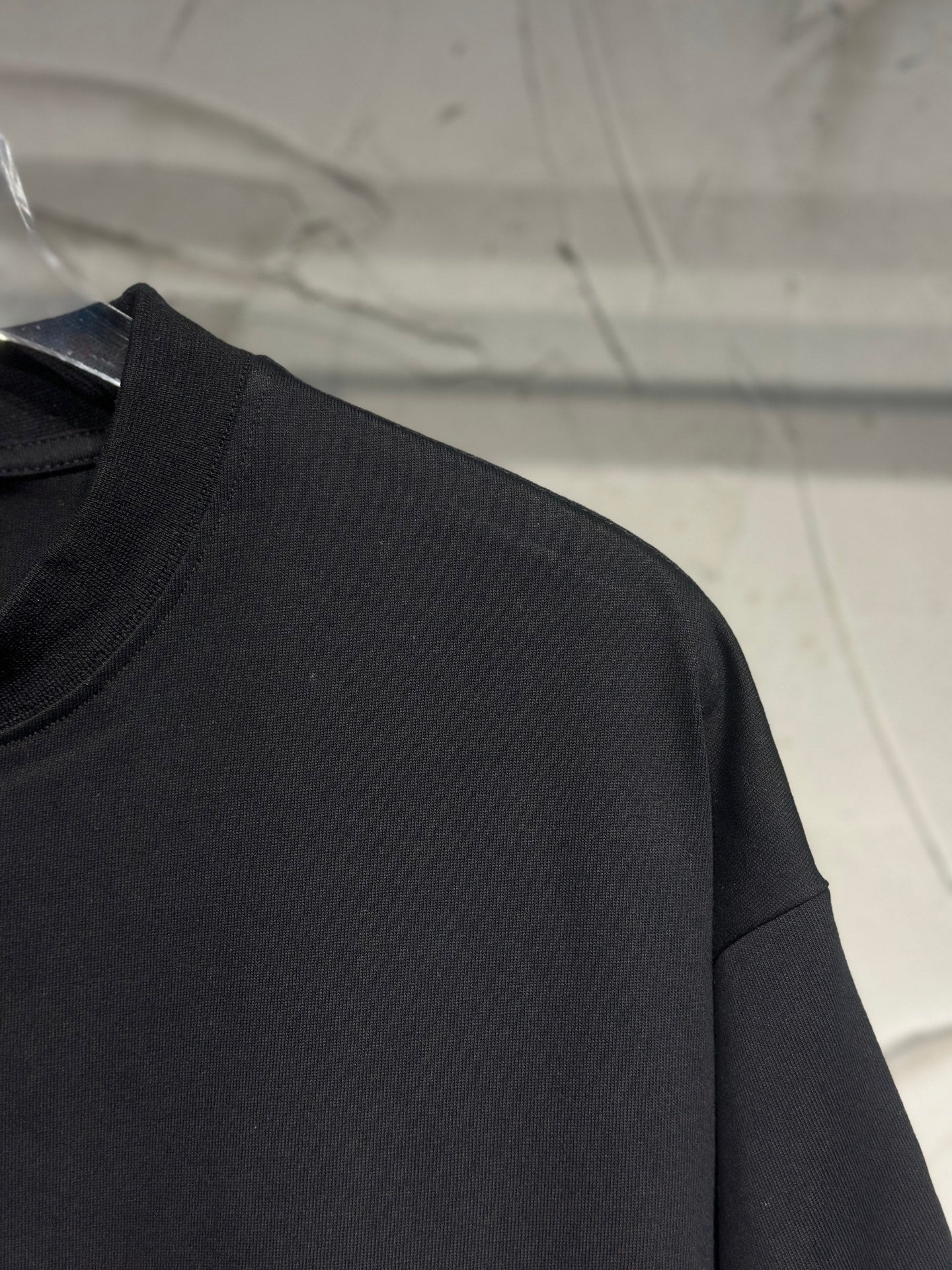 Black T-shirt sleeve and shoulder seam
