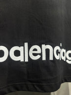 Black T-shirt with partial Balenciaga logo text at the lower hem