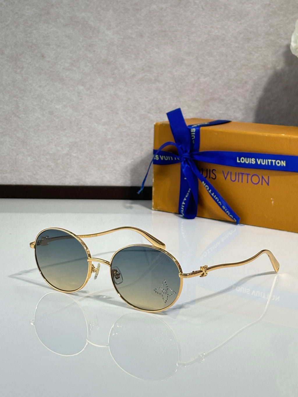 Louis Vuitton round sunglasses with gold frame and blue-to-gray lenses