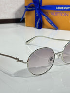 Louis Vuitton round sunglasses side view with silver frame and gray lenses
