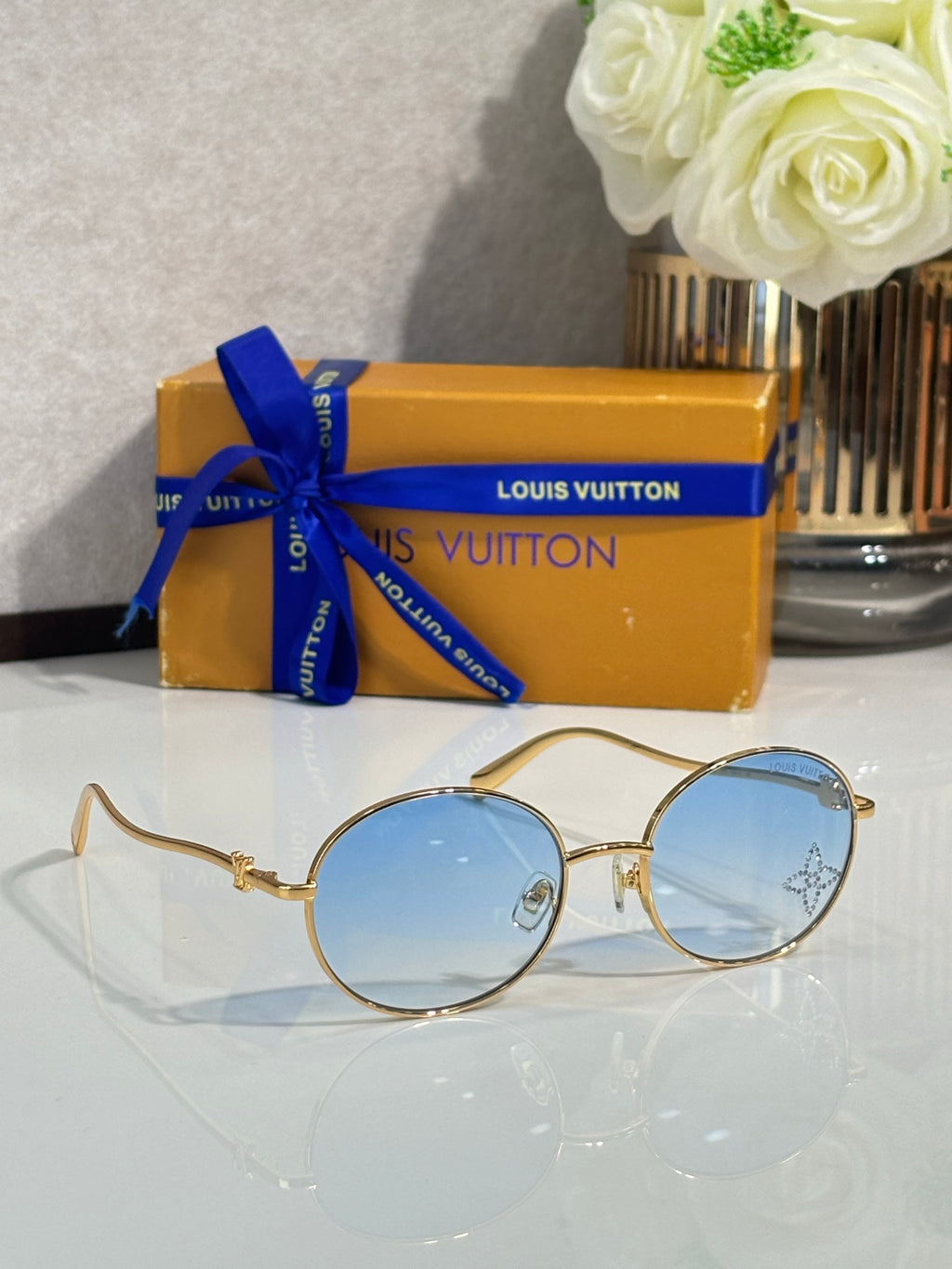 Louis Vuitton round sunglasses with gold frame and light blue lenses