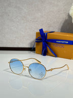 Louis Vuitton round sunglasses with gold frame and light blue lenses