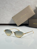 Bvlgari gold-tone sunglasses with light yellow gradient lenses and jeweled temple tips
