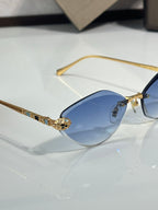 Bvlgari gold-tone cat-eye sunglasses with blue gradient lenses and jeweled bridge