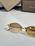 Bvlgari gold-tone round sunglasses with amber tinted lenses and jeweled side details