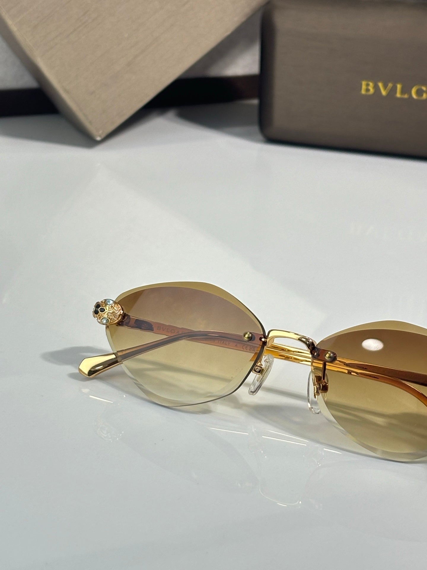 Bvlgari gold-tone round sunglasses with amber tinted lenses and jeweled side details