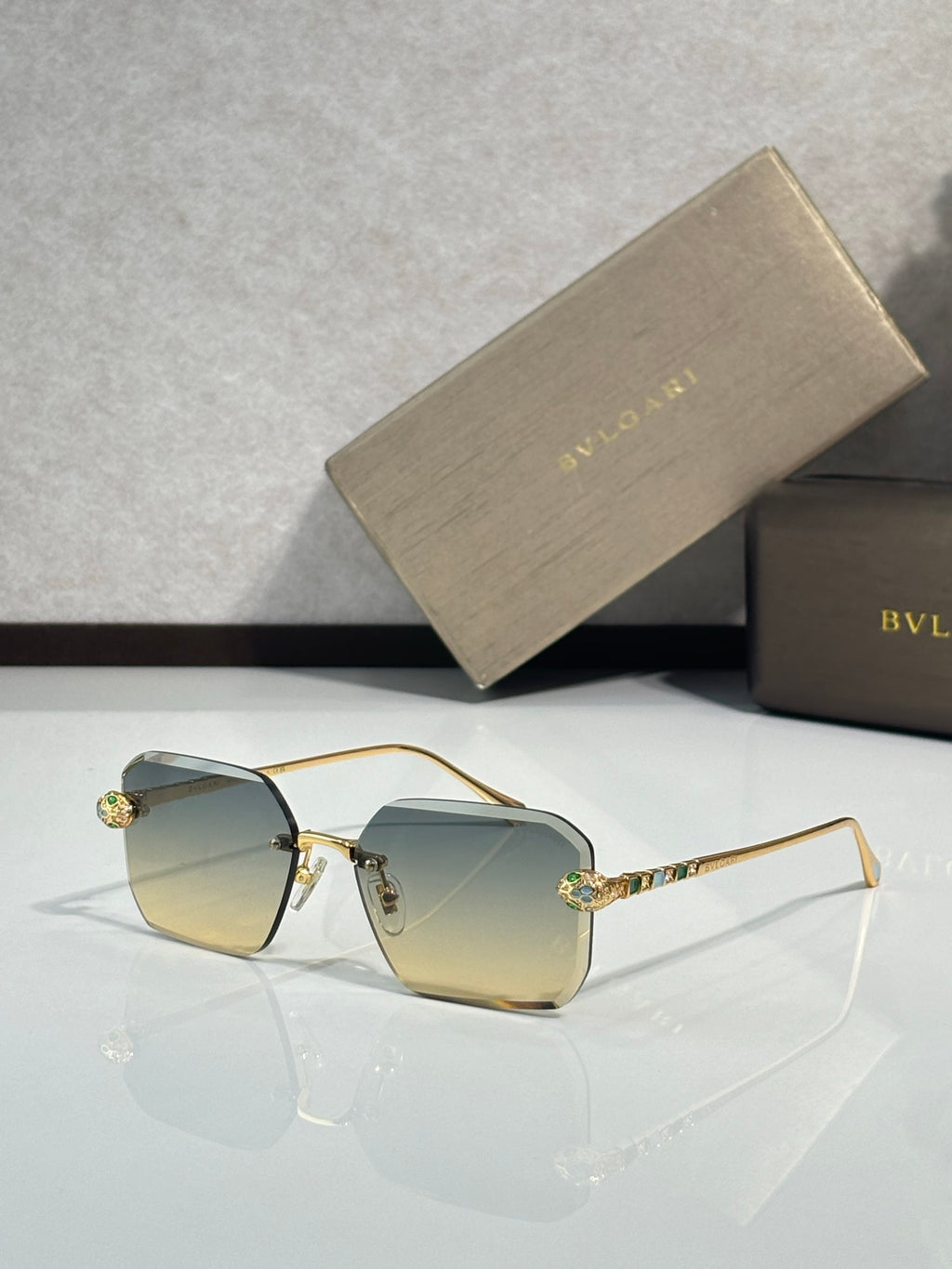 Bvlgari glasses, gold metal rectangular frames with light blue tinted lenses and jeweled temples