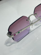 Bvlgari glasses, close-up of purple tinted lenses with gold frame and jewel-studded bridge