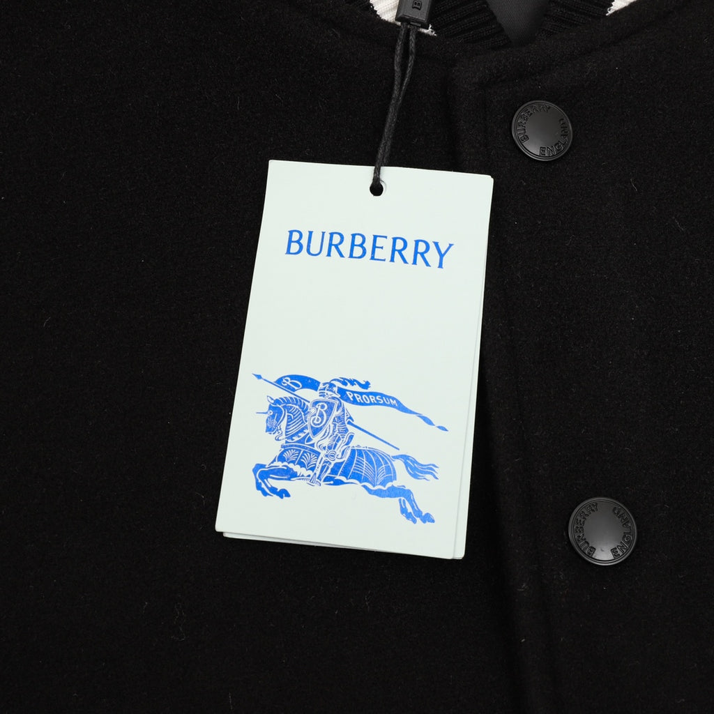 Burberry bomber jacket with hanging brand tag and snap button closure, chest area
