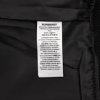 Burberry inner care label with material and country text on dark fabric