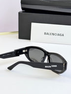 Black sunglasses with dark lenses and Balenciaga logo on side