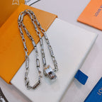Silver chain necklace with rectangular charm and lobster clasp on display