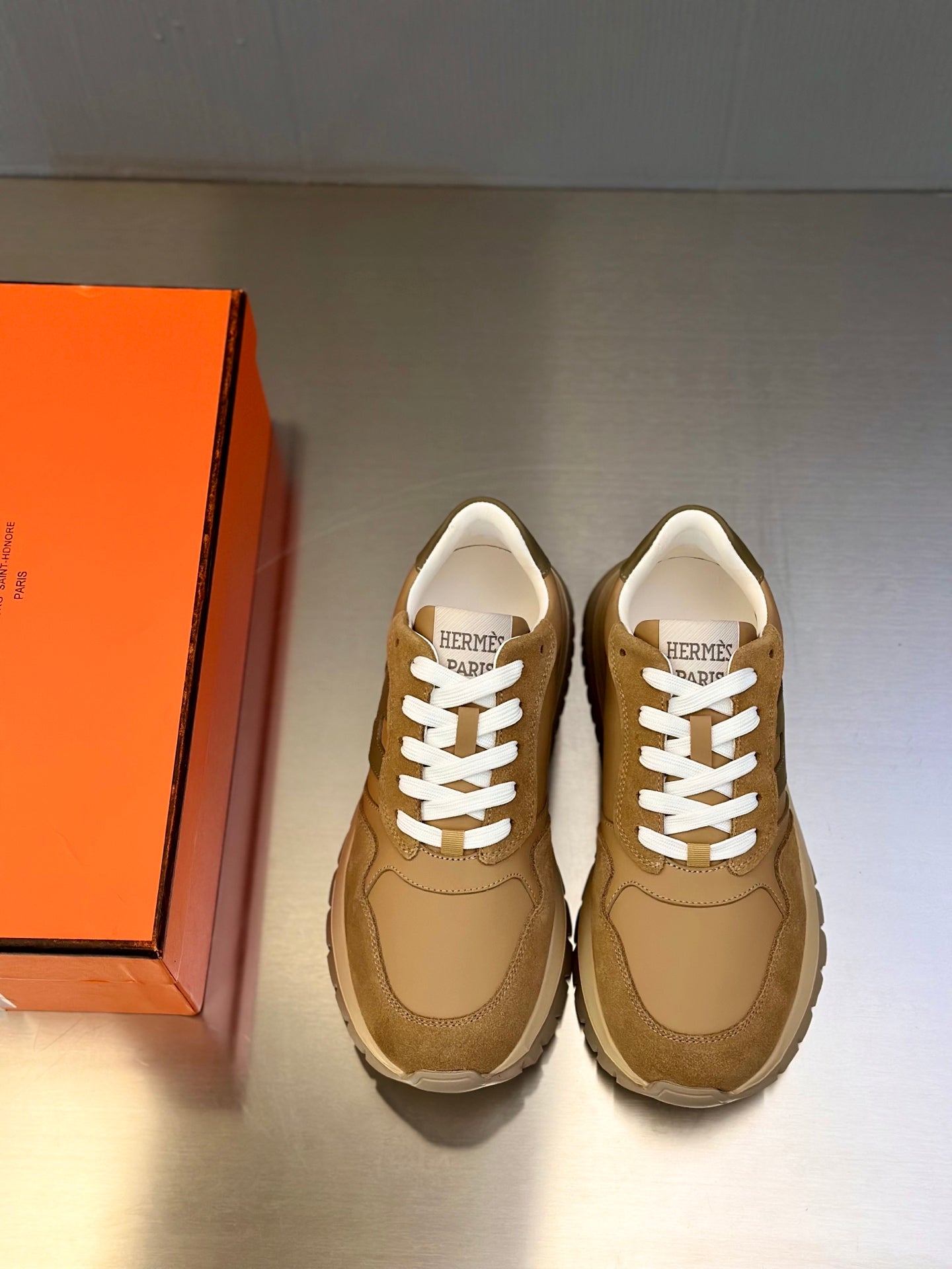 Tan lace-up sneakers with white laces and thick sole, pair view