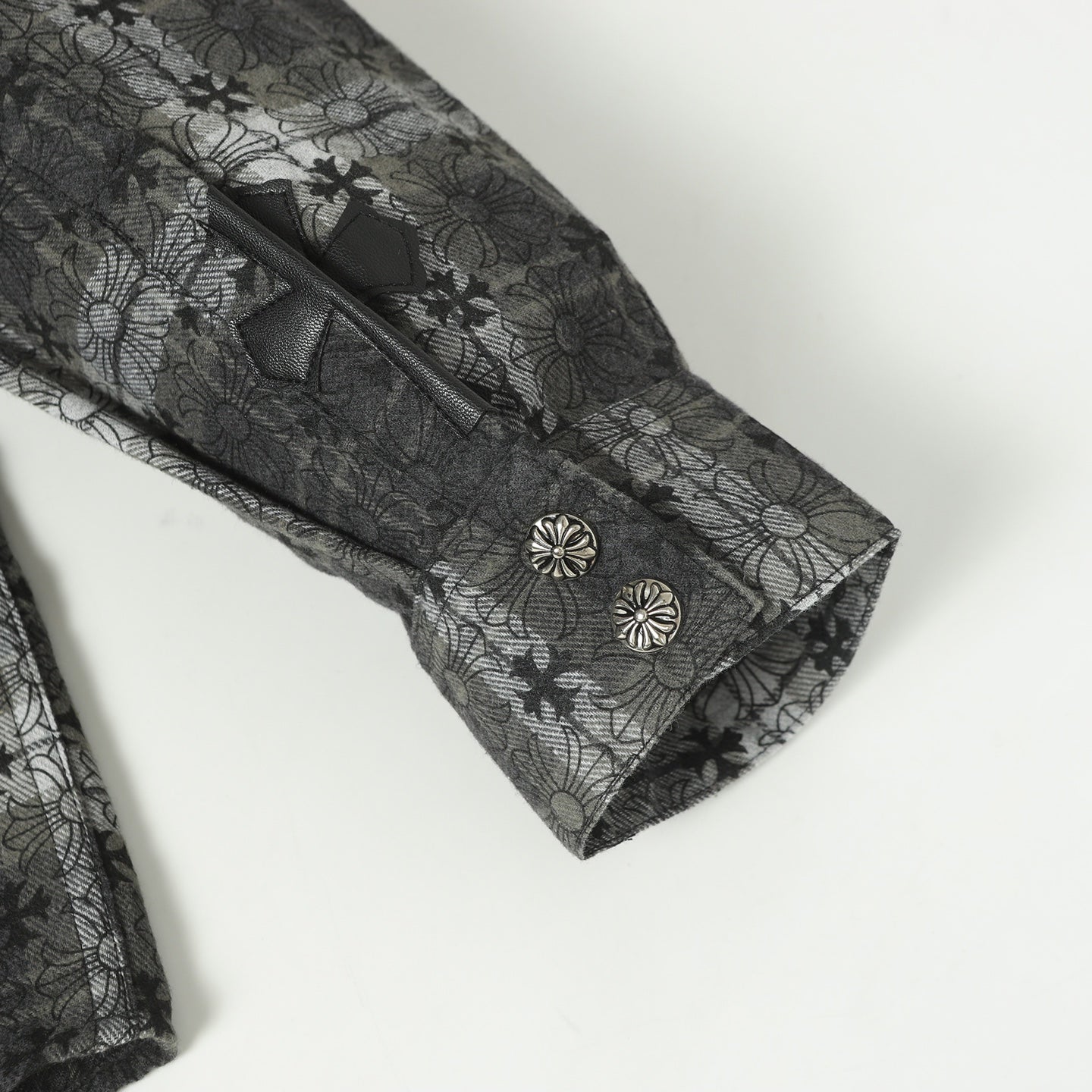 Dark gray long-sleeve button-up shirt cuff with buttoned detail