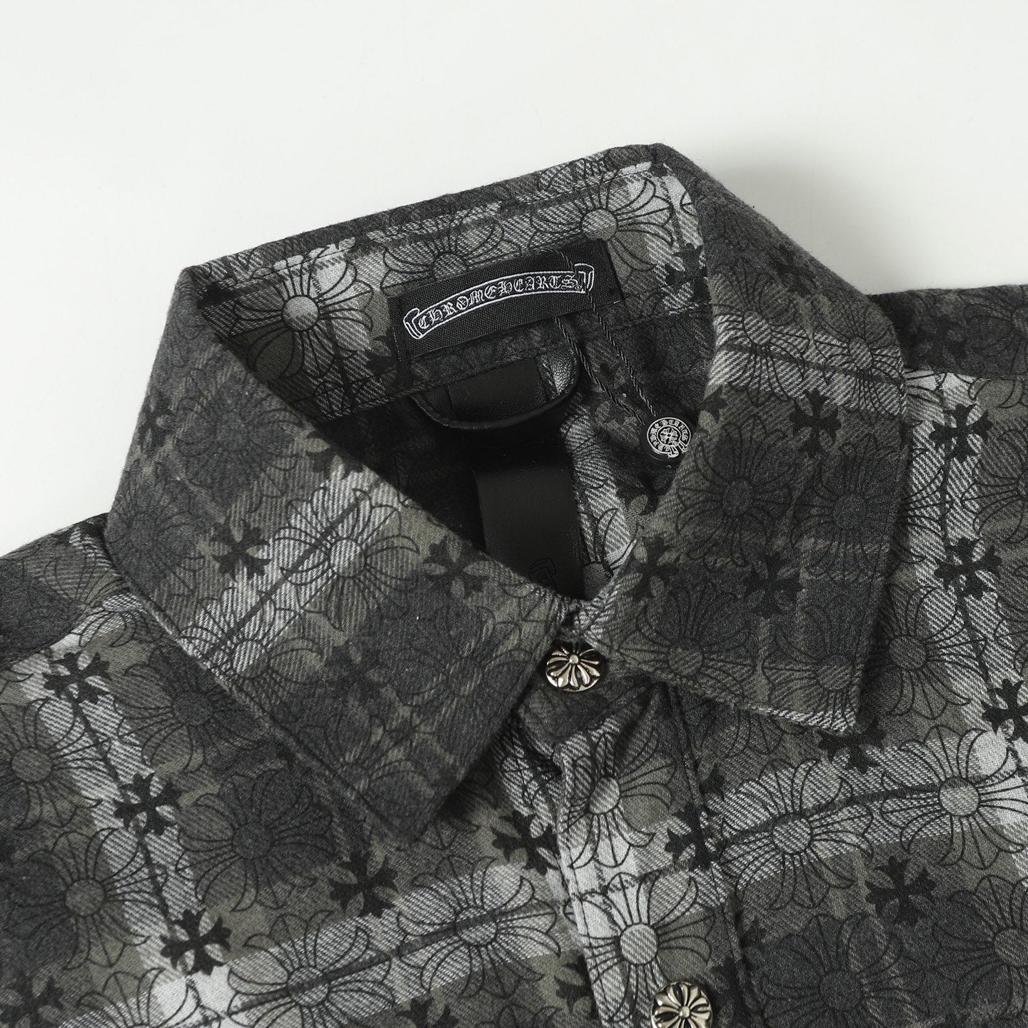 Dark gray patterned button-up shirt with pointed collar and decorative buttons