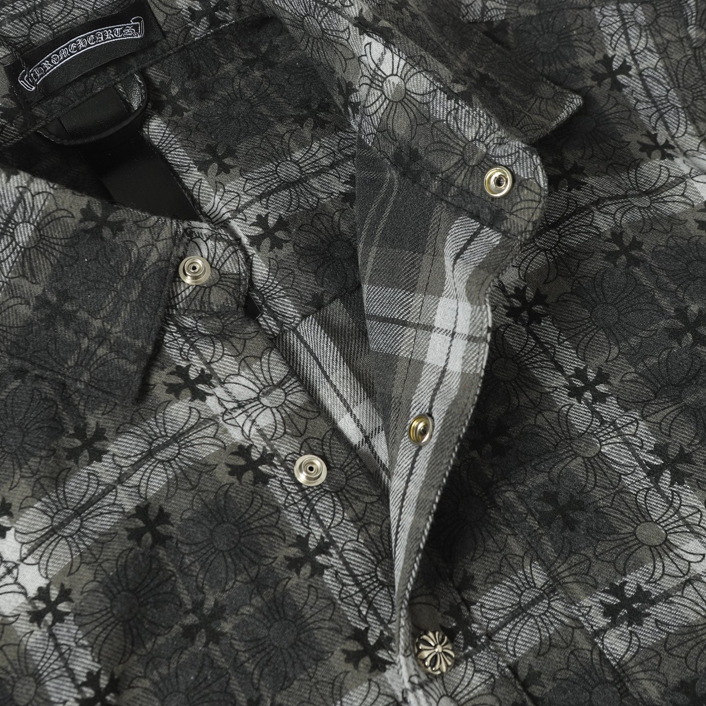 Dark gray button-up shirt front with collar, gold buttons, and placket