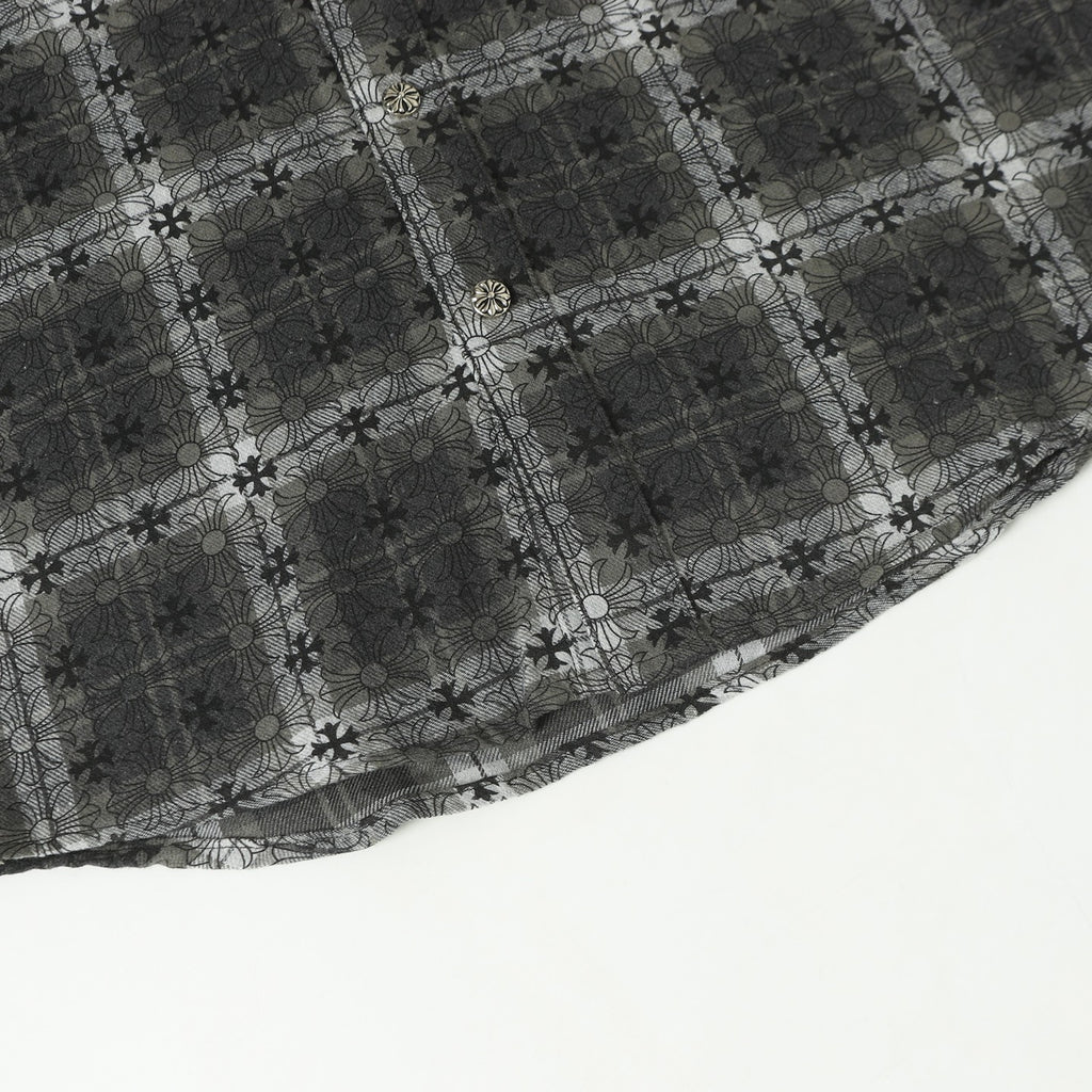 Dark gray floral-patterned button-up shirt hem with decorative trim