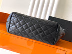 Black quilted leather bag with rolled top handle and diamond stitching