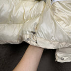 Long cream puffer jacket sleeve with elastic cuff and silver snap button