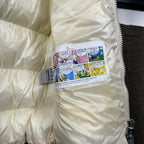 Moncler long cream puffer jacket, comic logo label near collar