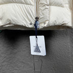 Off-white puffer jacket front with zipper pull and hanging tag