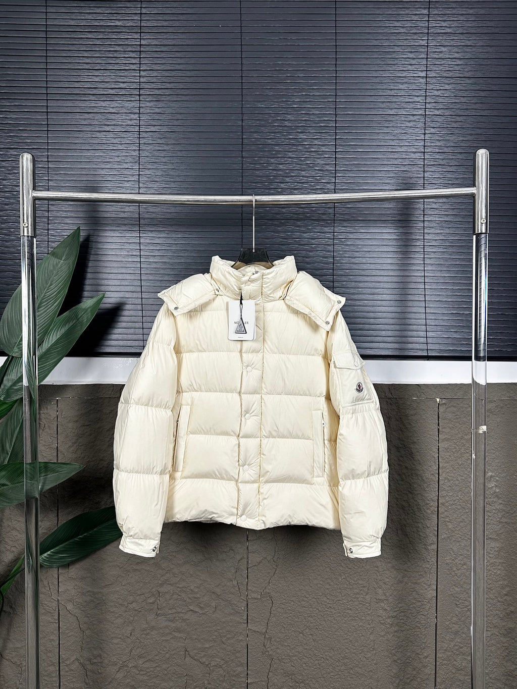 Long cream puffer jacket with hood and front zip, on hanger