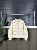 Long cream puffer jacket with hood and front zip, on hanger