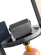 Crossbody bag front view with flap and strap, dark gray logo canvas