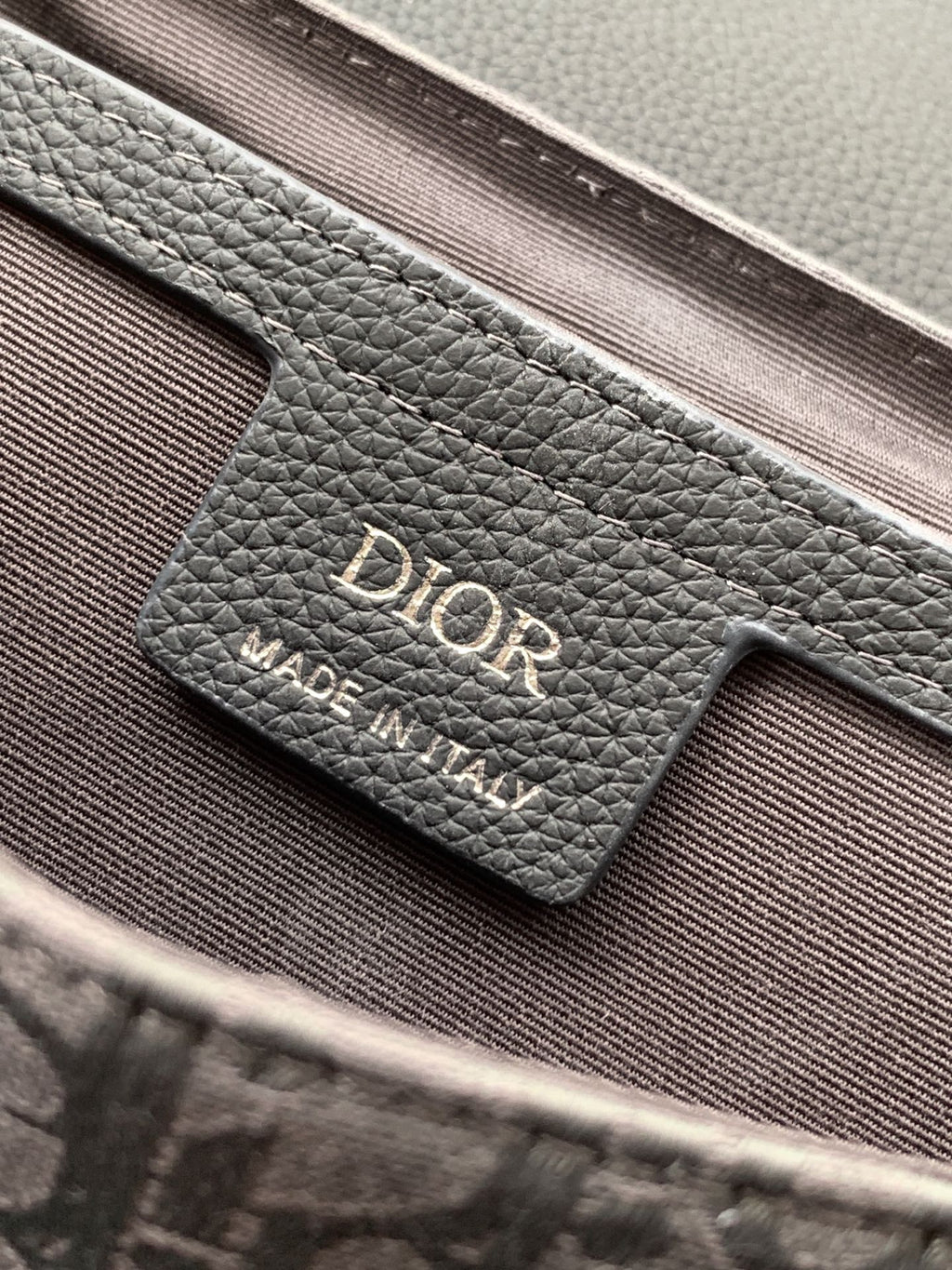 Crossbody bag logo label on leather, dark gray grain with Dior branding