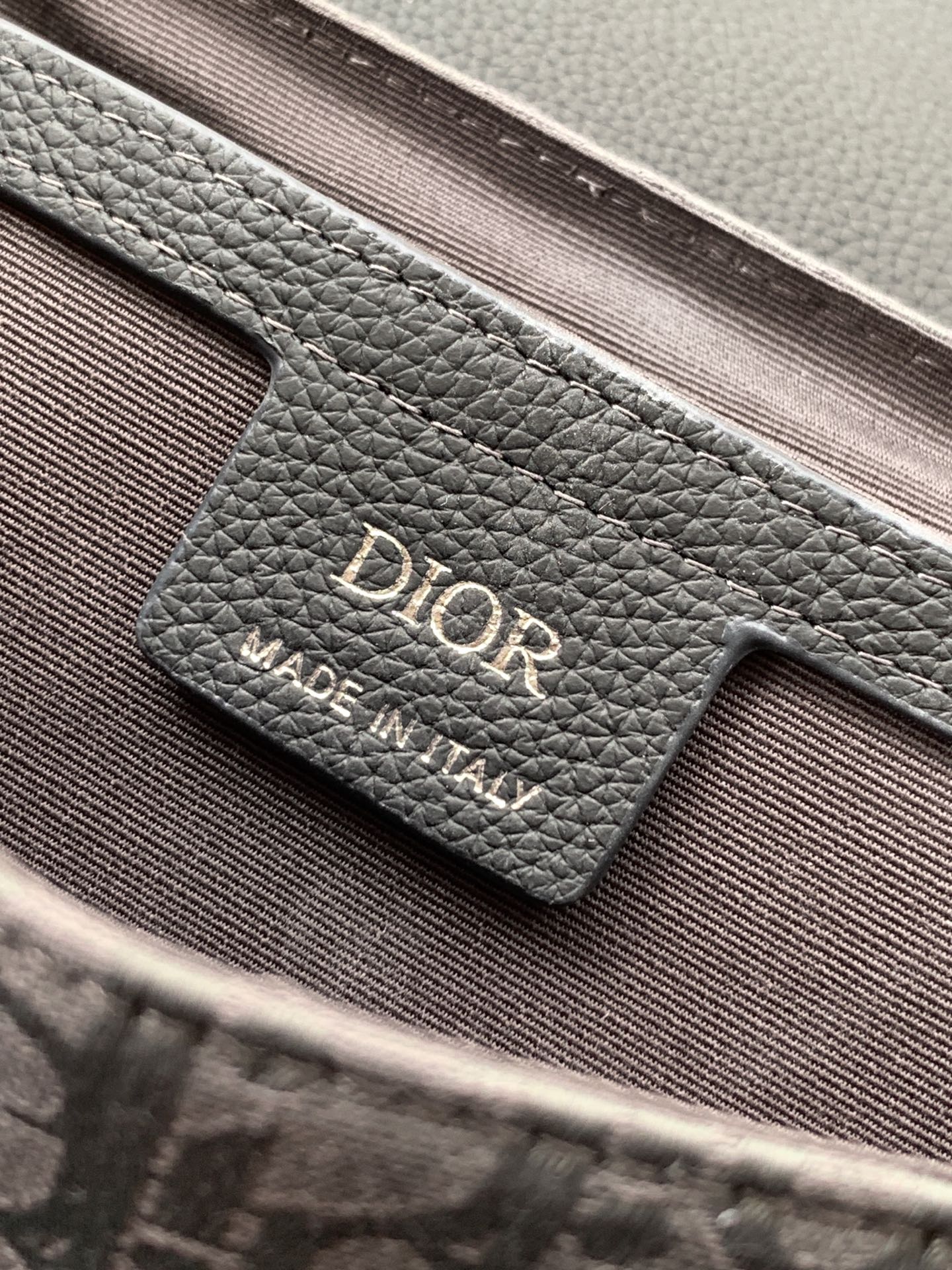 Crossbody bag logo label on leather, dark gray grain with Dior branding