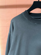 Dark teal long-sleeve sweatshirt with crew neck and smooth knit texture