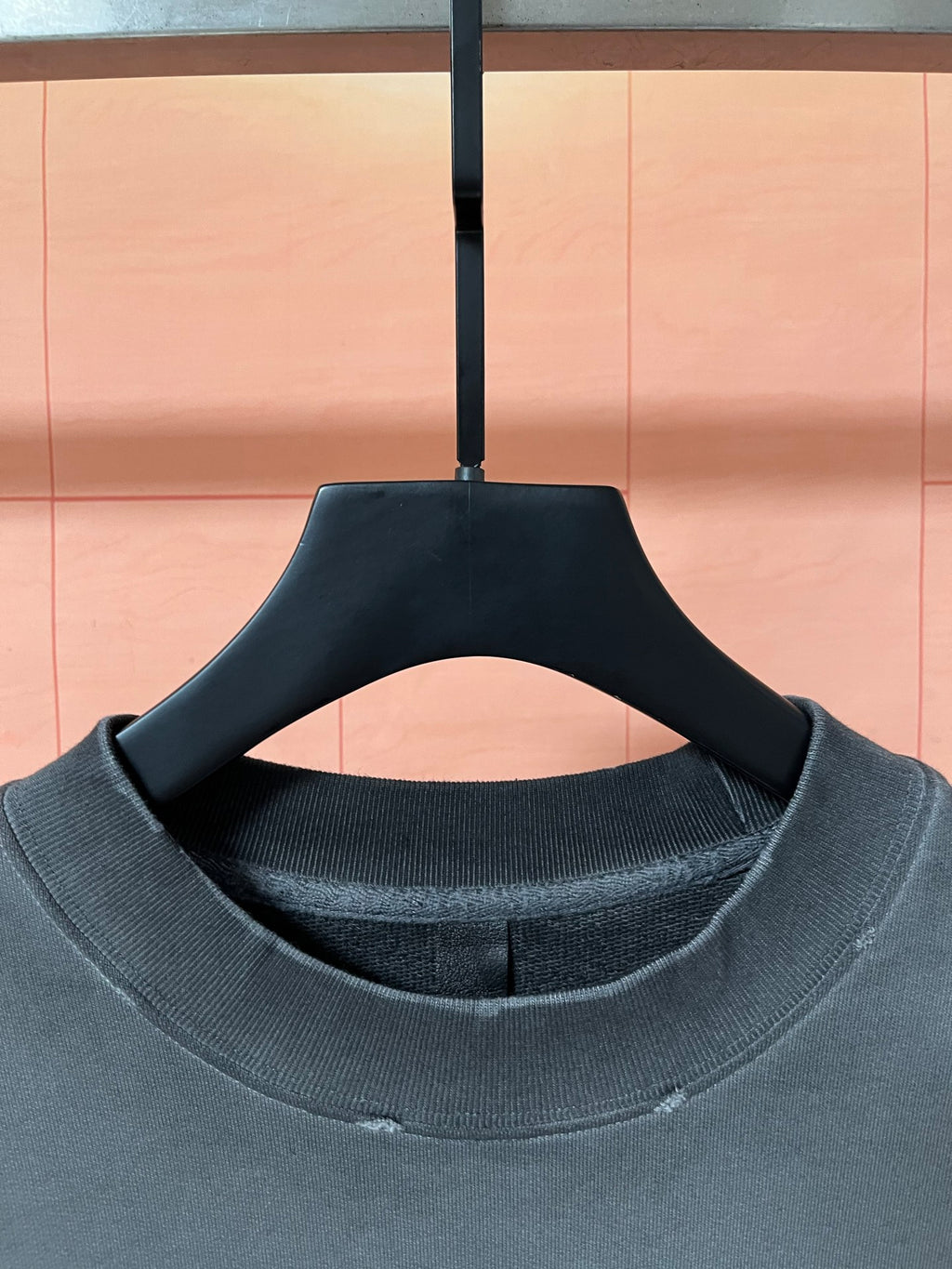 Dark teal ribbed crew neckline on long-sleeve sweatshirt