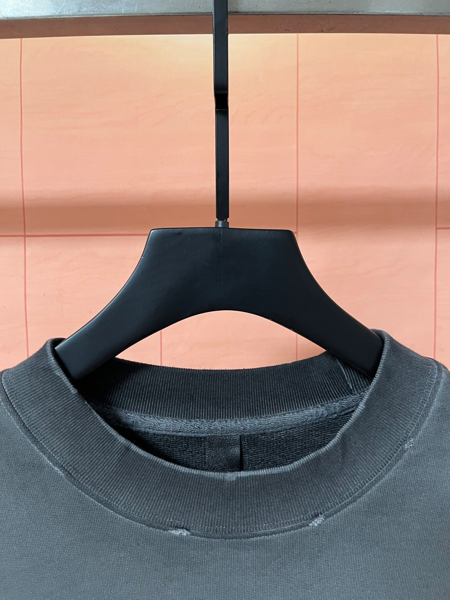 Dark teal ribbed crew neckline on long-sleeve sweatshirt