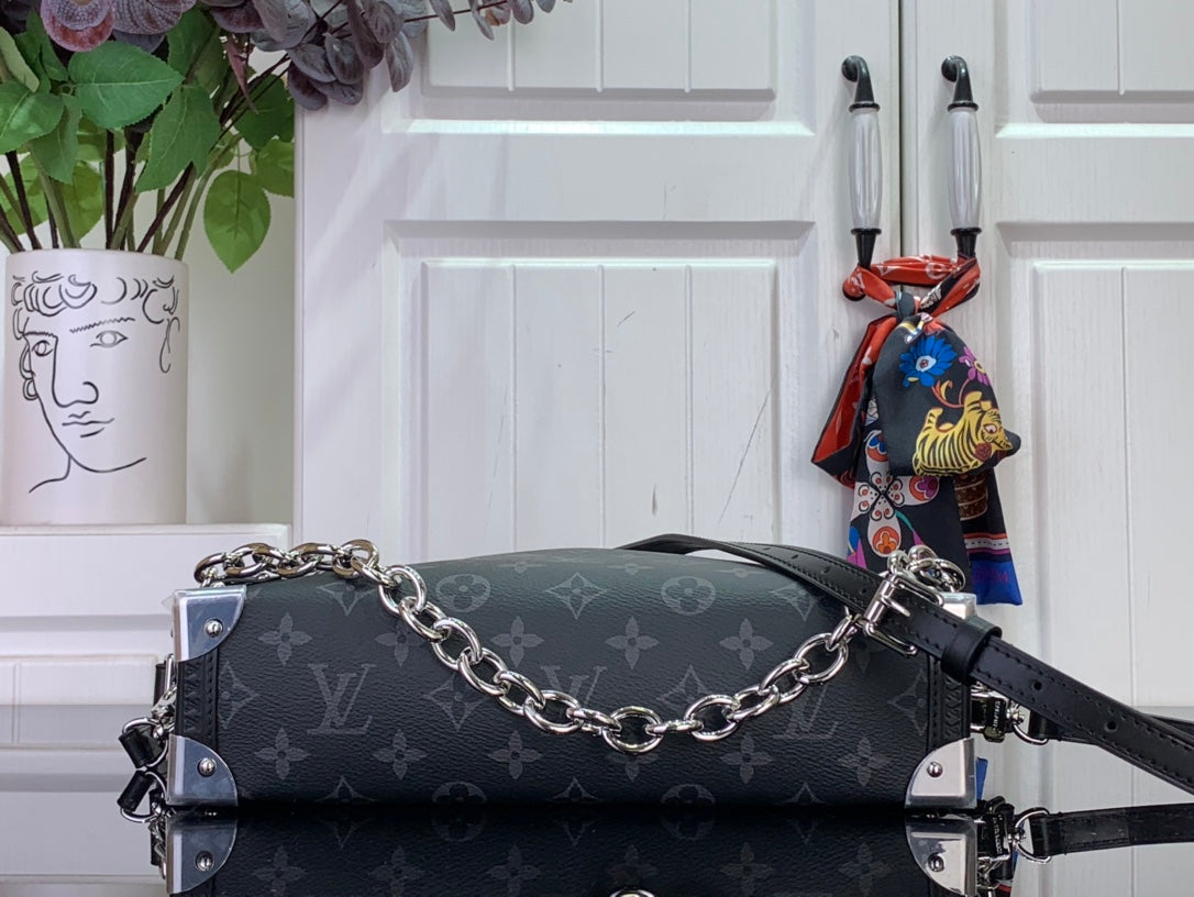 Dark monogram handbag with chain strap and silver-tone hardware, side view