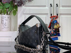 Dark monogram handbag with chain strap, top handle, and silver-tone corner details